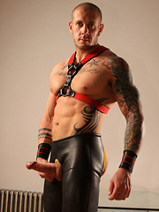 Harley dressed in leather trousers playing with own dick