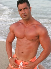 Beefy latino dad Leo Rojas posing on the beach