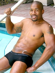 Black man posing by the pool